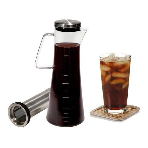 Handi Home cold brew coffee maker next to glass of cold brew coffee